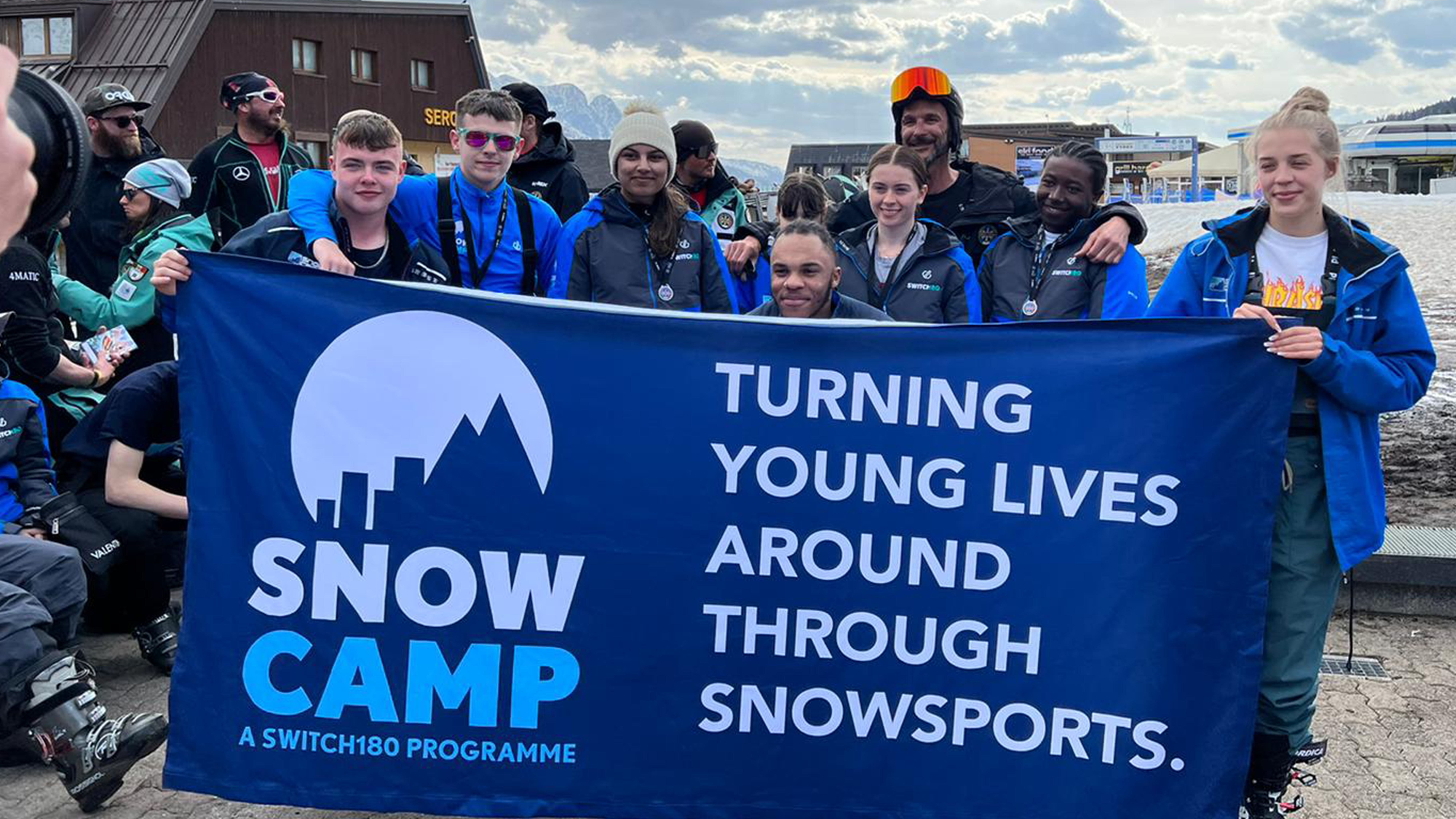 Hafsah and group with Snow Camp banner in Passo Tonale